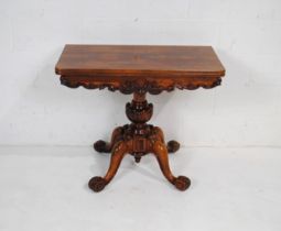 A William IV rosewood folding tea table, with carved decoration, raised on carved base with four