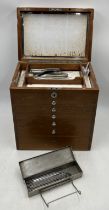 A vintage dentists medical set of drawers containing various tools and equipment