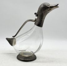 A silver plated and glass decanter in the form of a duck