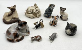 A collection of various cat figurines including Suzie Marsh seated Siamese, three De Rosa pieces,