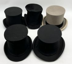 A collection of top hats and folding top hats including Gibus, Harrods, Dunn & Co, Woodrow etc.