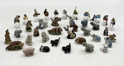 A collection of various Wade Whimsies along with a number of glass thimbles with cat decorations