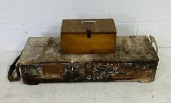 A wooden storage trunk along with a small wooden chest both containing various vintage hand tools