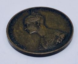 A small copper medal of Princess Victoria "Her Majority 1837" by William Wyon (after W. H.