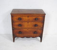 A Georgian fruitwood chest of three drawers of small proportions, with turned handles - length 81cm,