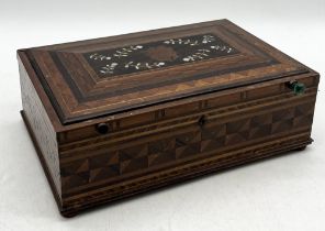 A turn of the century marquetry decorated sewing box with inlaid floral motif and blue lined