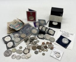 A collection of various coins including silver proof Krugerrand, Canadian Mint silver dollar,