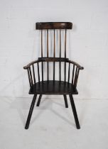 An antique elm and ash Welsh comb back chair, with curved top rail, raised on stick legs