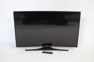 A Samsung BN68-06900B-00 47" TV, with remote control