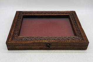 A wall hanging display cabinet with carved detailing - length 50cm, depth 38cm