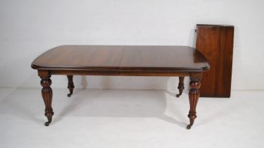 A Victorian style mahogany extending dining table, with one extra leaf, with a set of eight mahogany