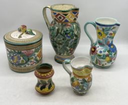 A collection of Italian pottery jugs, lidded jar etc. along with a Trentham jug