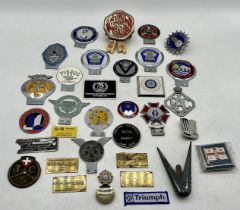 A collection of vintage car grill badges including Woolbridge Motor Club, Seven-Fifty Motor Club,