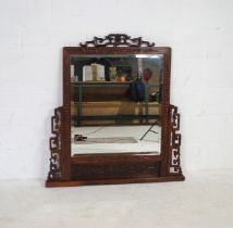 A Chinoiserie hardwood overmantel mirror, with carved & pierced decoration and bevel edged glass -