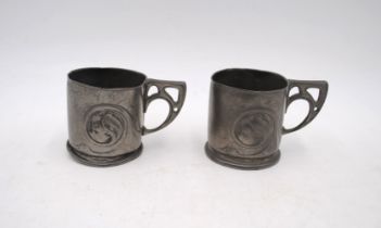 A pair of Arts and Crafts Liberty 'Tudric' pewter tankards, with scroll leaf motif design