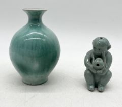 A Chinese celadon water dropper in the form of a monkey along with a small vase in similar style