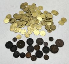 A collection of copper tokens and pennies along with a quantity of spade guinea gaming tokens