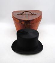 A vintage black felt top hat by 'B. A. Dunn & Co' of London, with leather hat box