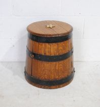 A converted antique oak metal bound rum barrel, with brass star decoration to lid - height 46cm