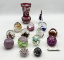A collection of paperweights including Caithness along with a bohemian glass vase etc.