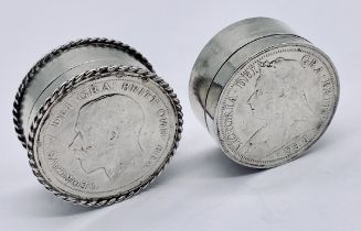 Two hallmarked silver pill pots both set with silver coins