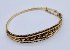 A Victorian 9ct gold hinged bracelet with scroll design, weight 10.3g