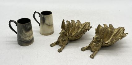 A pair of gilt bronze griffins, possibly trinket trays, along with a pair of turned horn cups with