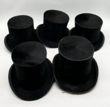 A collection of five vintage top hats including makers A.J. White, Hanbridge, Scott & Co., Austin