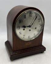 An Edwardian mahogany mantle clock with silvered dial and Arabic numerals
