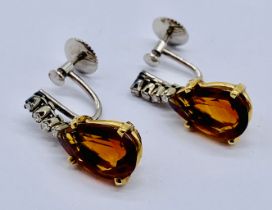 A pair of drop earrings in 18ct gold set with diamonds and tear drop shaped topaz/quartz