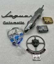 A small selection of vintage Jaguar car accessories including car bonnet mascot and Jaguar Drivers