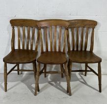 Three pine Windsor slat back chairs two with F.S. stamped on the back, one with C.J. stamped on