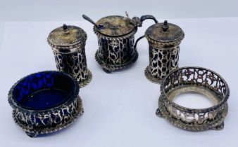 A hallmarked silver condiment set comprising of pepperettes, salts (missing/damaged liners) and a