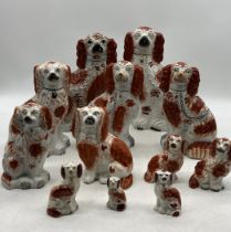 A collection of various Staffordshire and Staffordshire style dogs