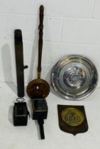 A collection of miscellaneous items including a vintage Rolls Royce hub cap, bed warmer,