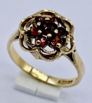 A garnet cluster ring set in 9ct gold, size J