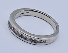 A platinum half eternity ring set with diamonds. The ring comes with a gemologist report from the