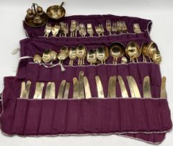 A large collection of brass and wood cutlery including condiment set