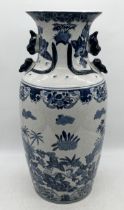 A 20th century oriental floor vase decorated with cherubs and formed handles - 63cm high