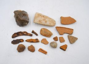 A collection of archeological and geological finds, including a chert core, axe heads, pottery