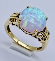 A 9ct gold ring set with an opal style stone, size N