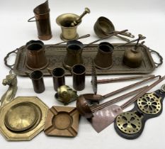 A collection of various brass and copper including pestle and mortar, measuring cups, inlaid tray