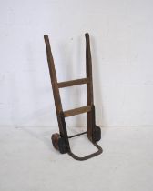 A set of vintage wooden sack trucks, possibly Railway related, stamped 'HMOW-B' to sides