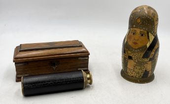 A small modern telescope in fitted box along with a set of Babushka dolls