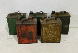 A collection of five vintage petrol cans including Pratts, Esso etc