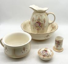 A Crown Devon blush coloured jug and bowl set with chamberpot, brush pot and soap dish