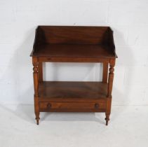 A turn of the century mahogany washstand, with single drawer and turned supports, raised on