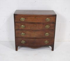 A Georgian mahogany bow-fronted chest of four drawers of small proportions, with brass handles -