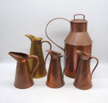A quantity of copper jugs, with one brass