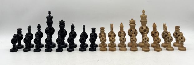 A carved wooden puzzle ball chess set